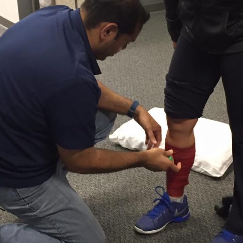 Dynamic mobility technique with compression band to improve calf flexibility.